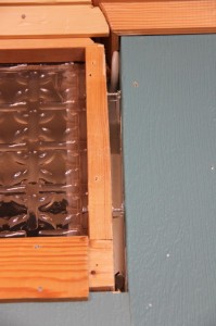 The top of the wall with the godawful glass inserts. And a hole through into the bedroom. 